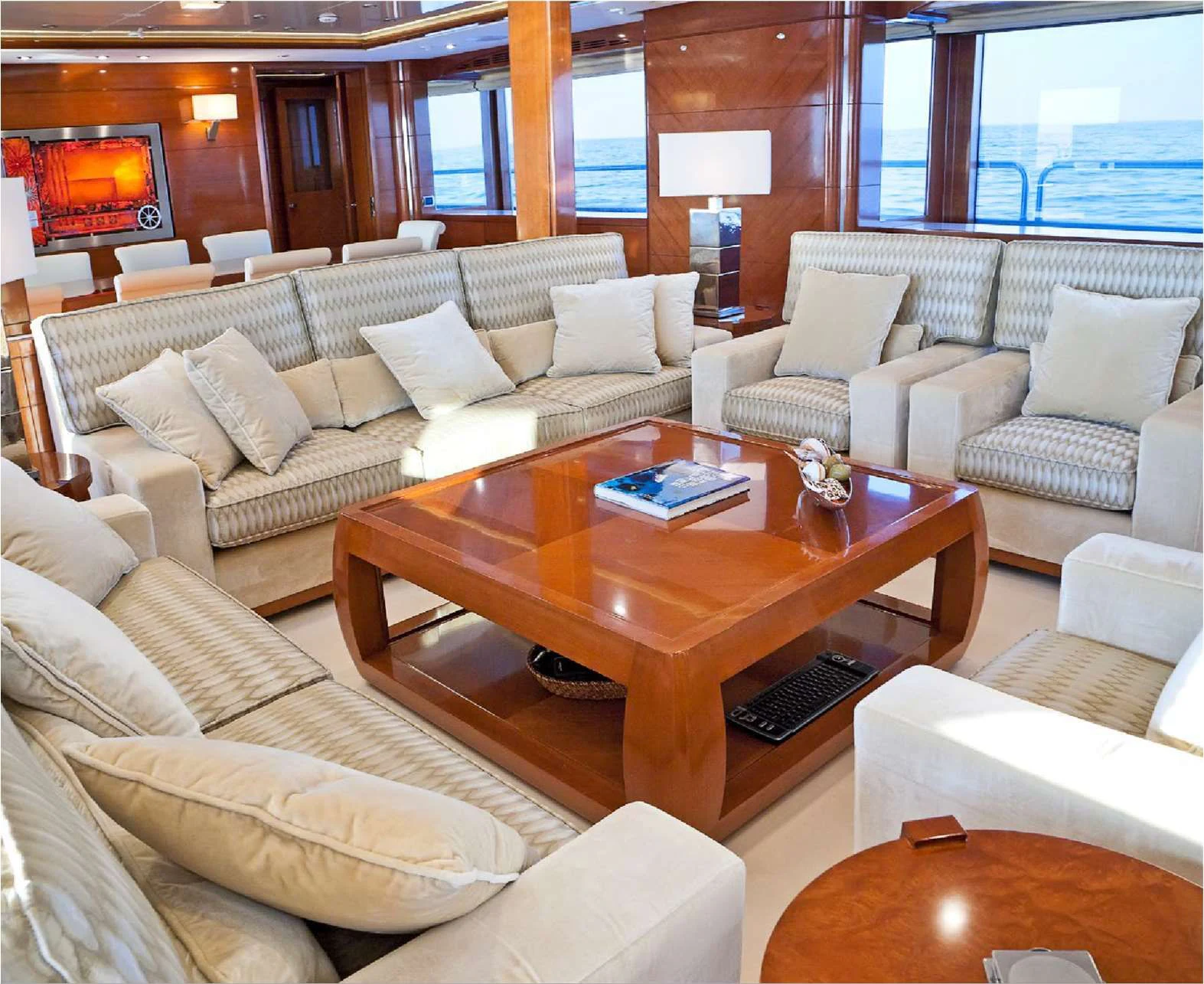 a living room with a table and couches aboard EVERBLUE Yacht for Sale