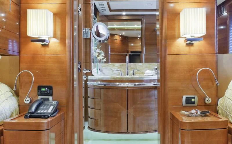 a wooden cabinet with a mirror and a phone on it aboard EVERBLUE Yacht for Sale