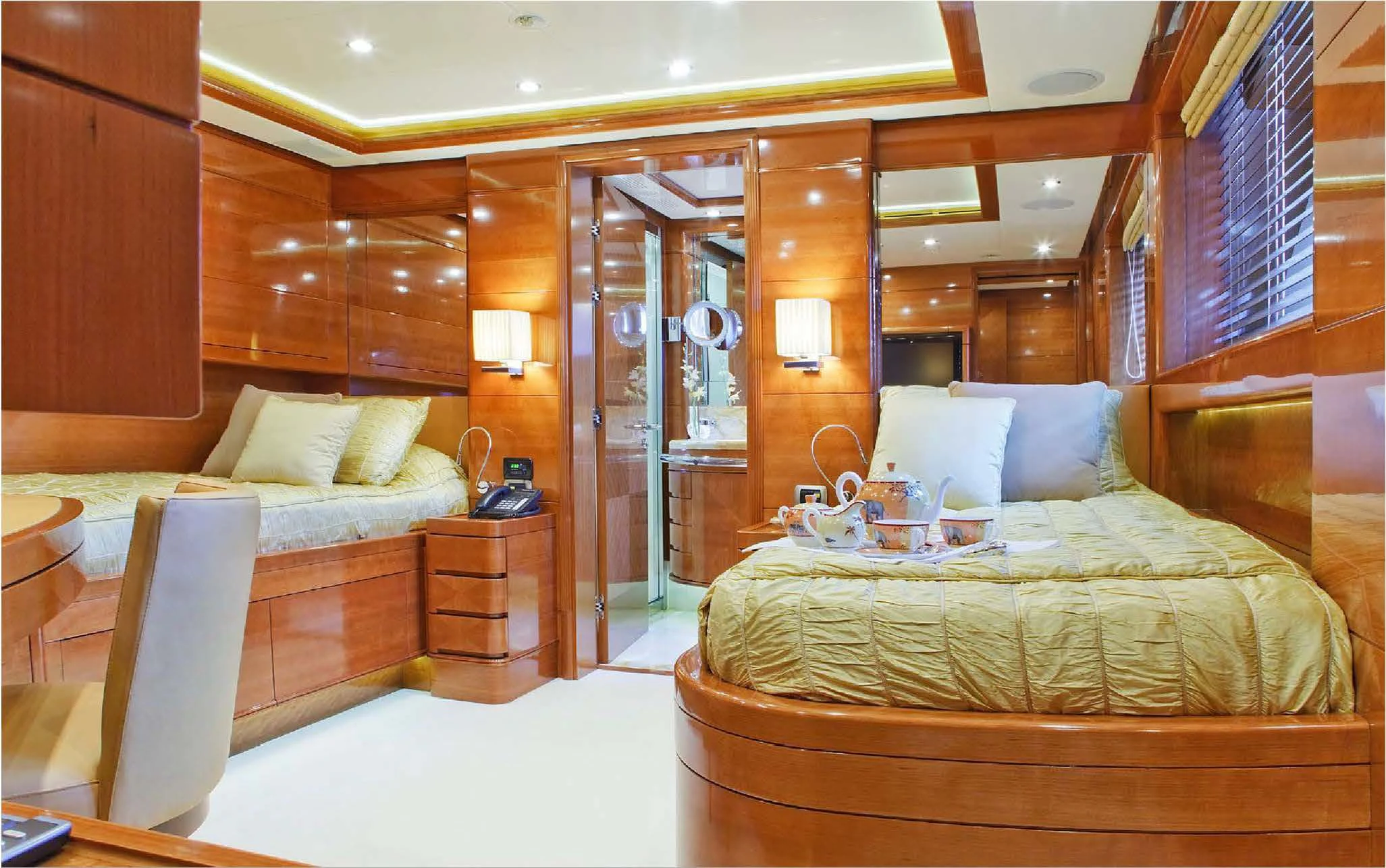 a room with a bed and a mirror aboard EVERBLUE Yacht for Sale