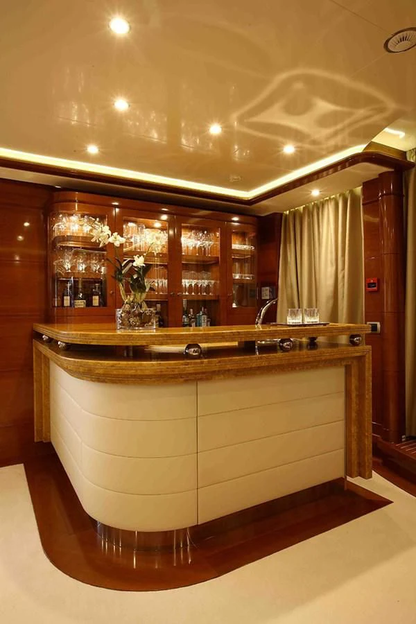 a large wooden cabinet with glass doors aboard EVERBLUE Yacht for Sale