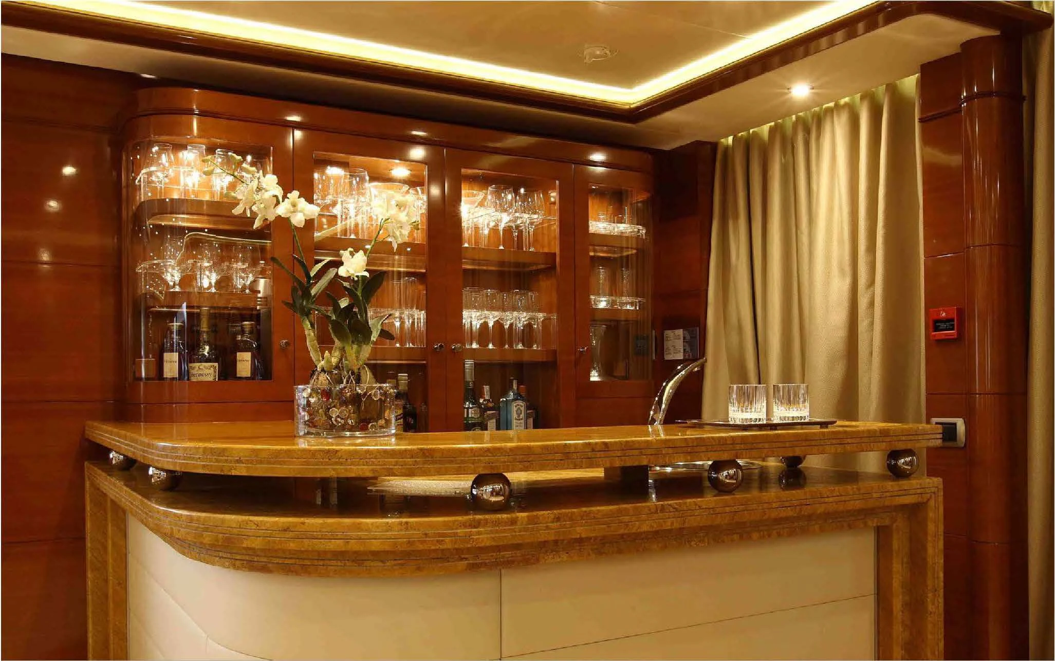 a glass cabinet with a vase of flowers on it aboard EVERBLUE Yacht for Sale