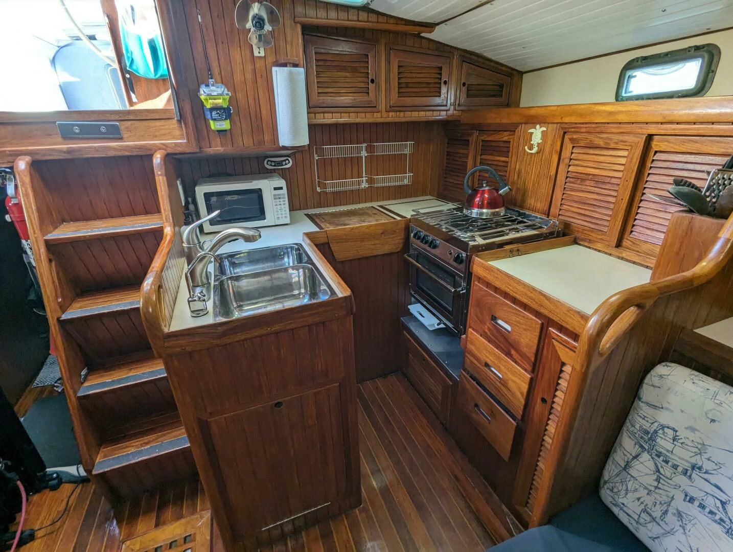 a kitchen with wooden cabinets aboard ANDIAMO Yacht for Sale
