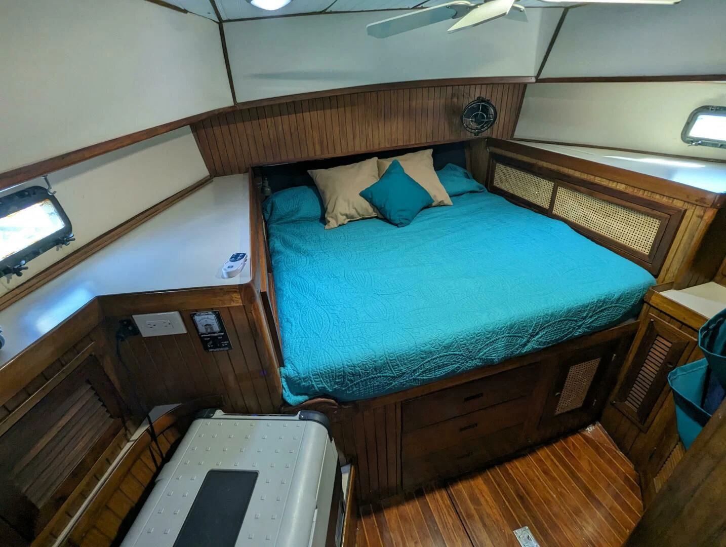 a bed with a blue comforter aboard ANDIAMO Yacht for Sale