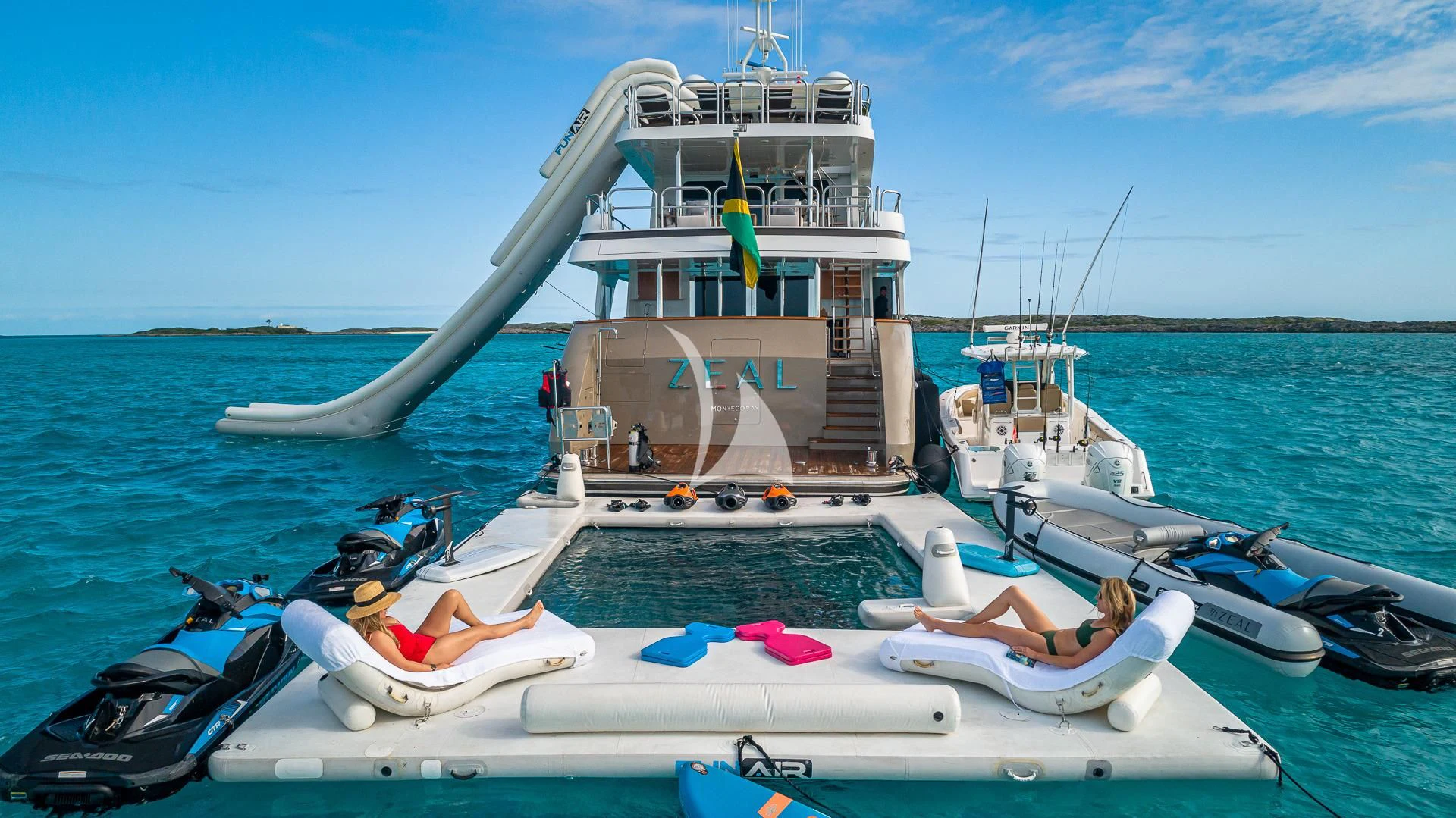 a person lying on a lounge chair on a boat in the water aboard SEA CLASS Yacht for Sale