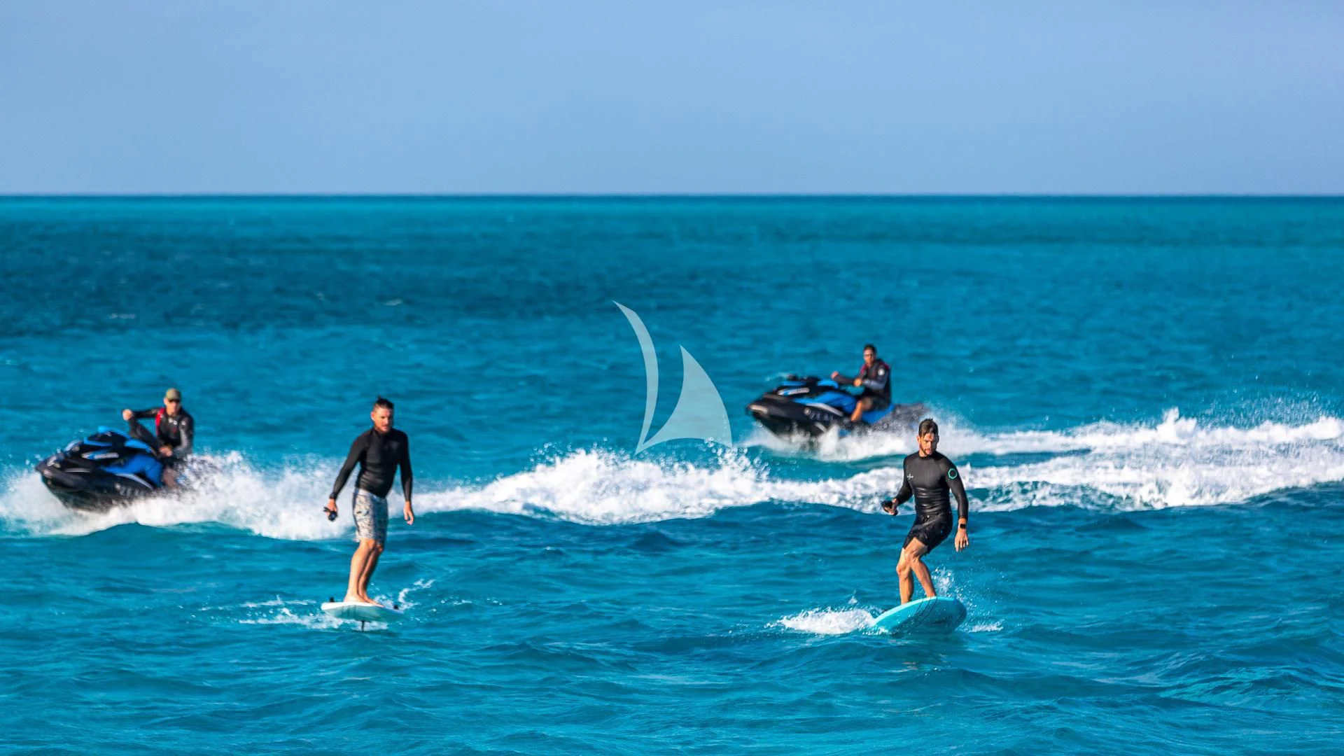 surfers riding waves in the ocean aboard SEA CLASS Yacht for Sale