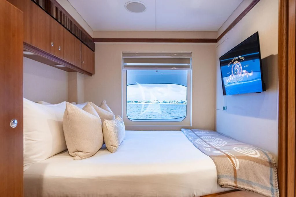 a bed with a television on the wall aboard SEA CLASS Yacht for Sale