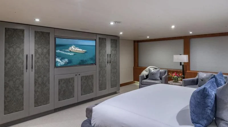 a large bedroom with a large tv aboard SEA CLASS Yacht for Sale