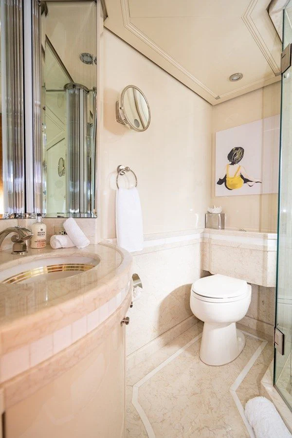 a bathroom with a sink toilet and a mirror aboard SEA CLASS Yacht for Sale