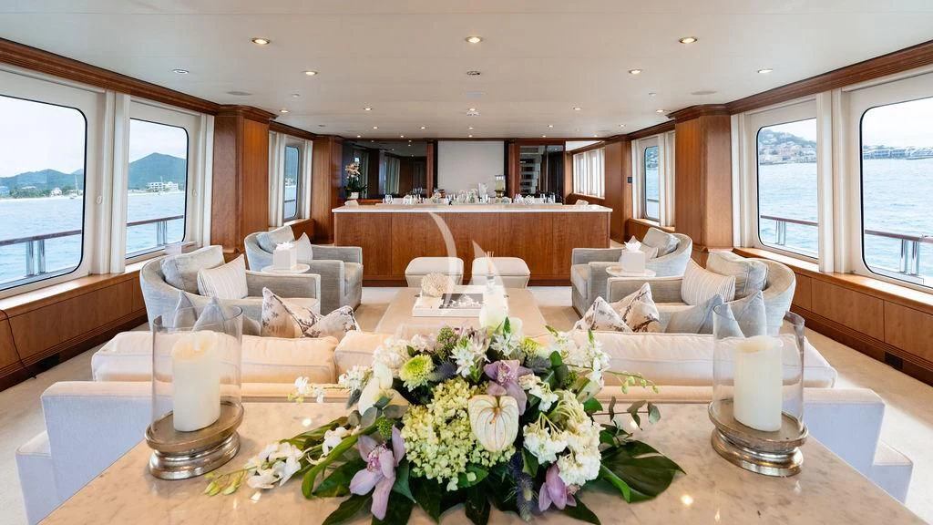 a living room with a table and chairs aboard SEA CLASS Yacht for Sale