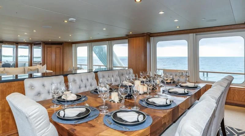 a large dining room with a large table and chairs aboard SEA CLASS Yacht for Sale
