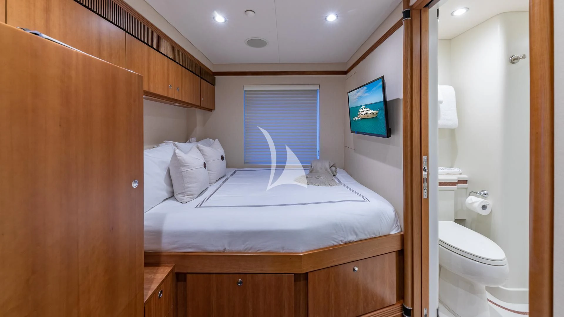 a bedroom with a bed and a television aboard SEA CLASS Yacht for Sale