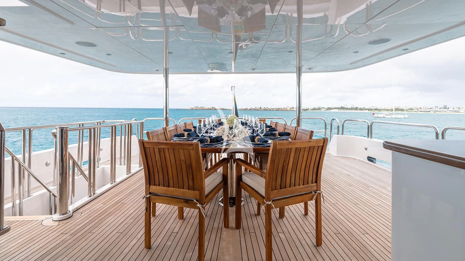 a table and chairs on a deck overlooking a large body of water aboard SEA CLASS Yacht for Sale