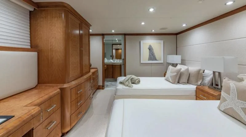 a room with a bed and a dresser aboard SEA CLASS Yacht for Sale