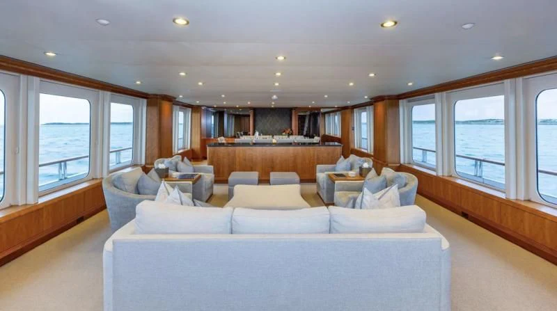 a living room with a large sofa aboard SEA CLASS Yacht for Sale