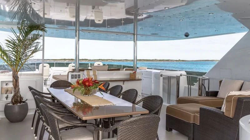 a table and chairs on a patio aboard SEA CLASS Yacht for Sale