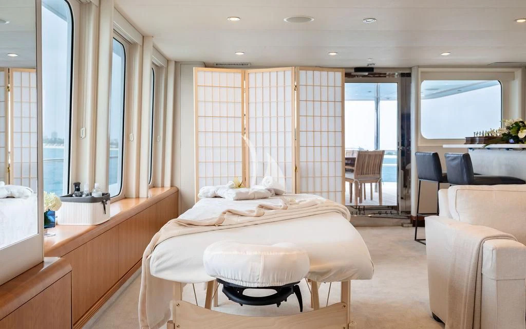 a room with a bed and a chair aboard SEA CLASS Yacht for Sale