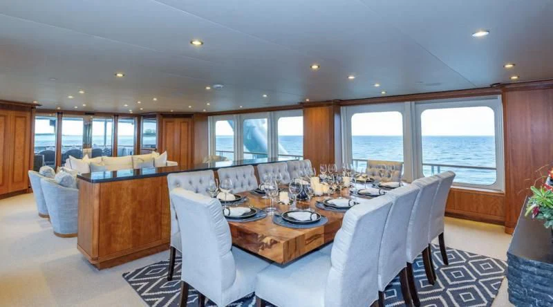 a large dining room with a large table and chairs aboard SEA CLASS Yacht for Sale