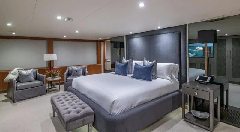 a large bedroom with a bed and a desk aboard SEA CLASS Yacht for Sale