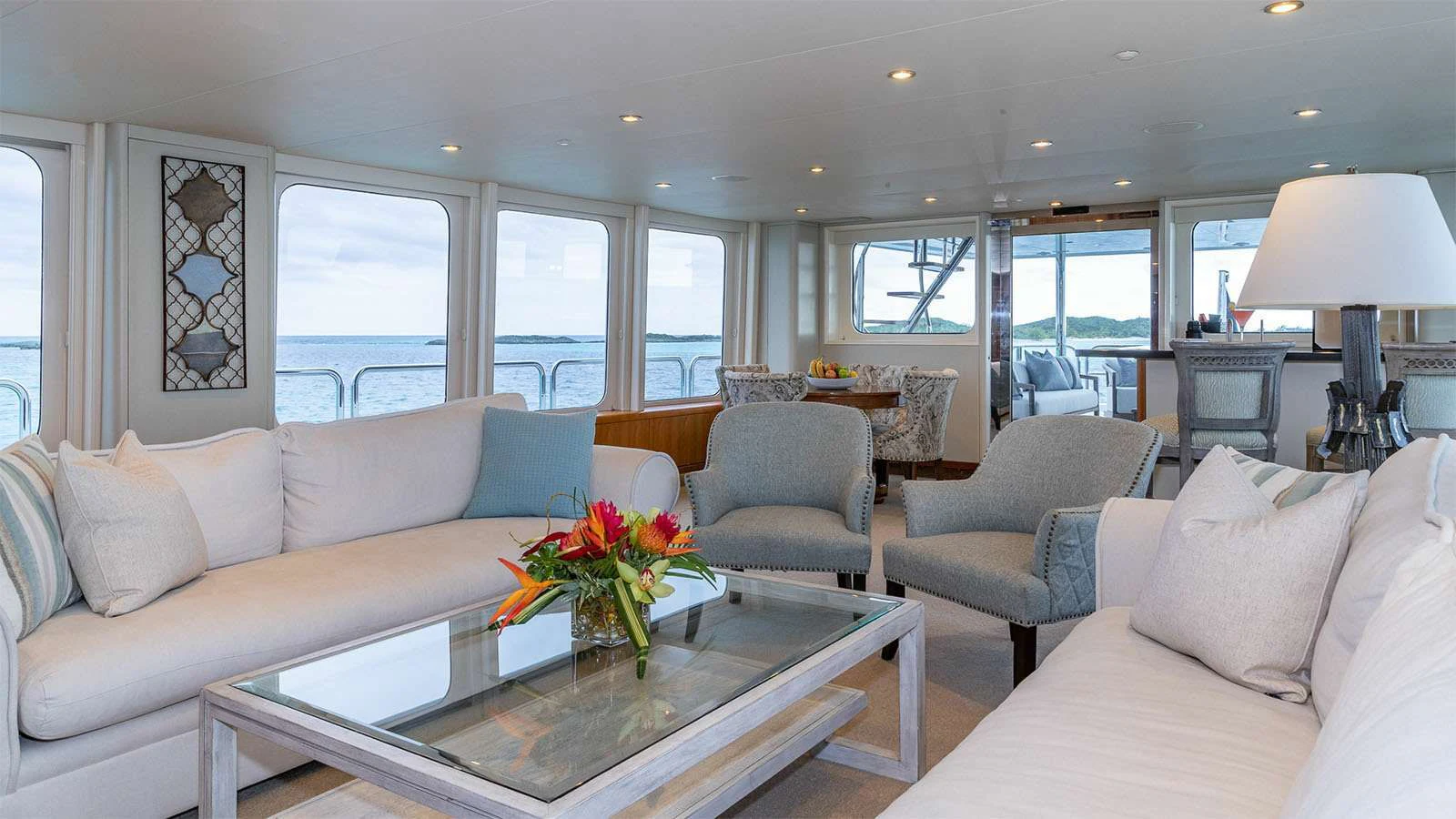 a living room with a table and chairs aboard SEA CLASS Yacht for Sale