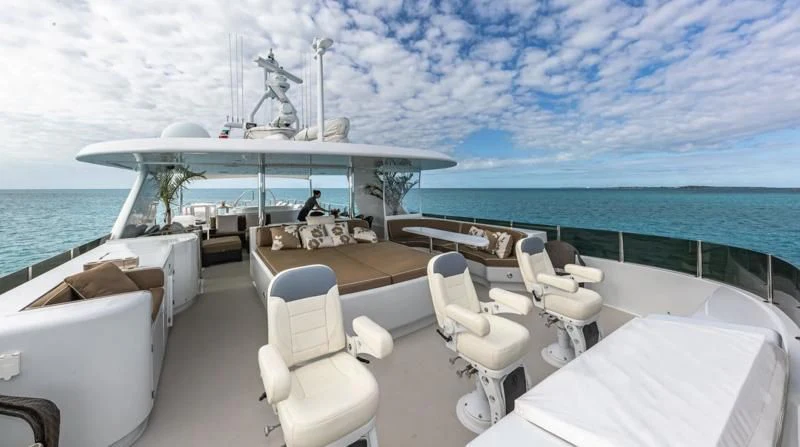a room with a table chairs and a large body of water aboard SEA CLASS Yacht for Sale