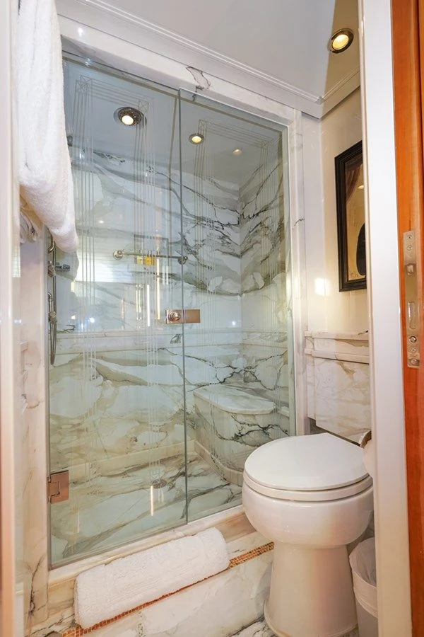 a bathroom with a glass shower aboard SEA CLASS Yacht for Sale