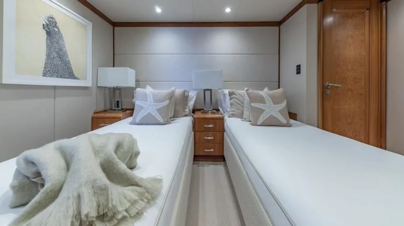 a room with a bed and a dresser aboard SEA CLASS Yacht for Sale
