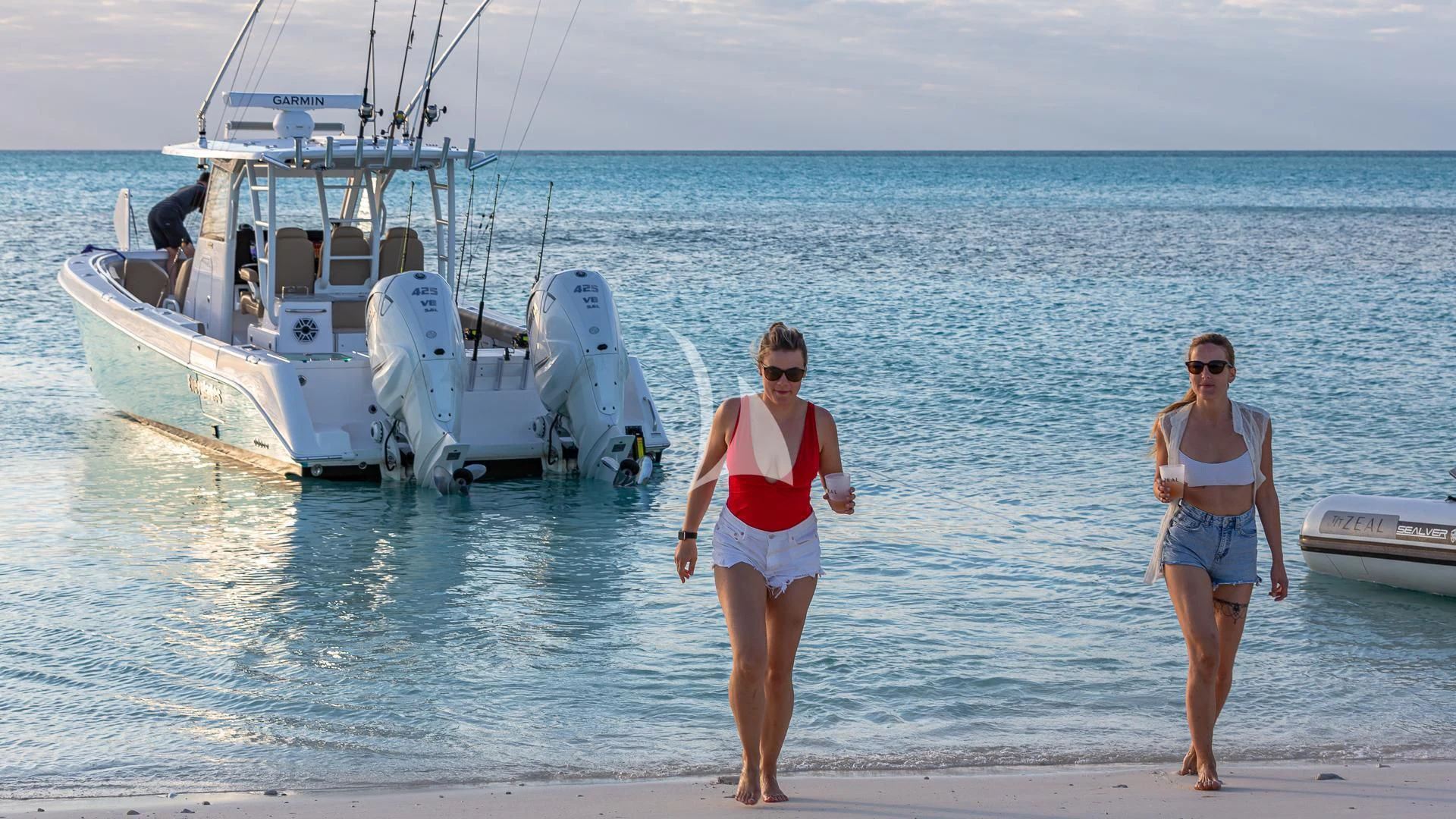 two women walking on a beach aboard SEA CLASS Yacht for Sale