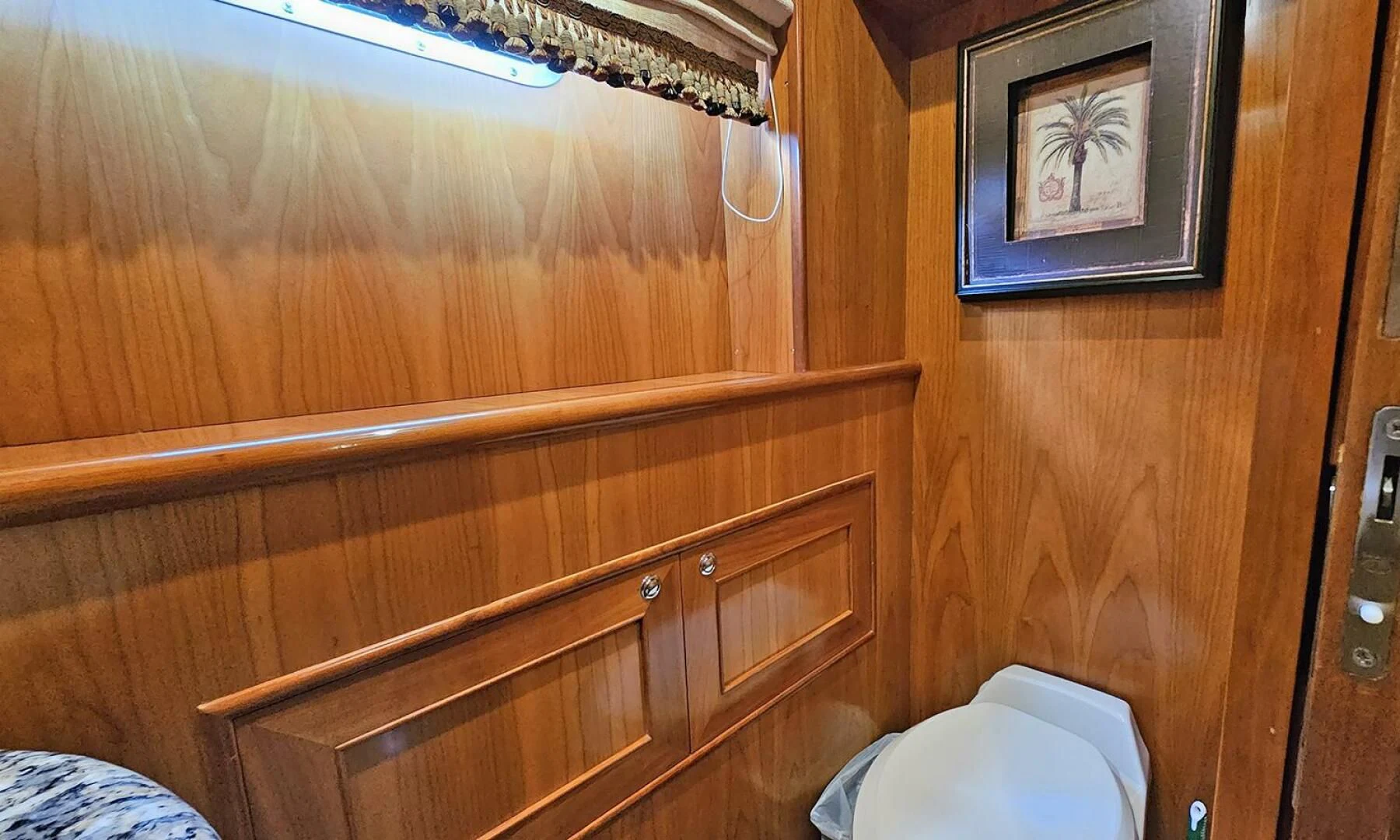 a bathroom with wood cabinets aboard MY KIMBERLY Yacht for Sale