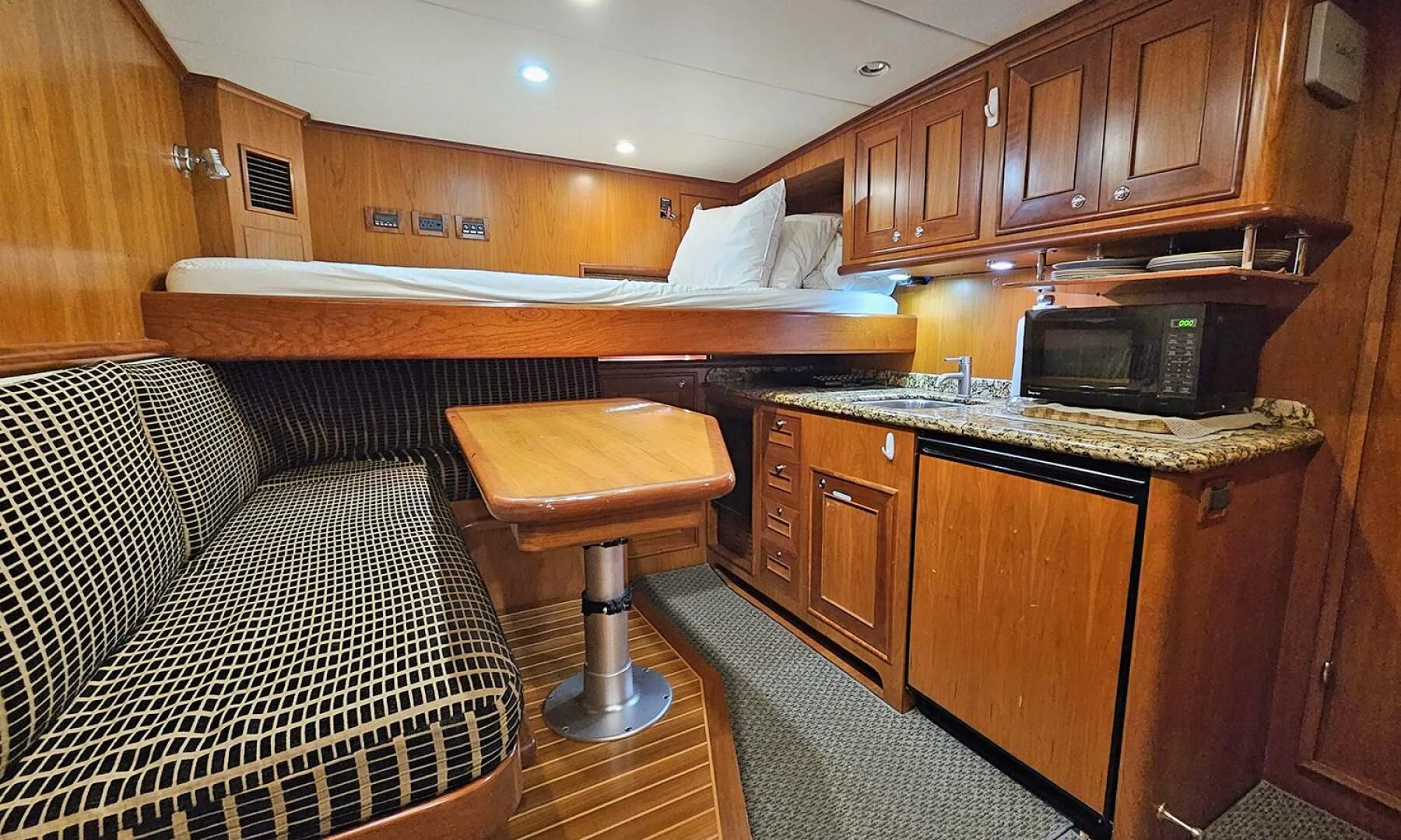 a kitchen with a couch and a television aboard MY KIMBERLY Yacht for Sale