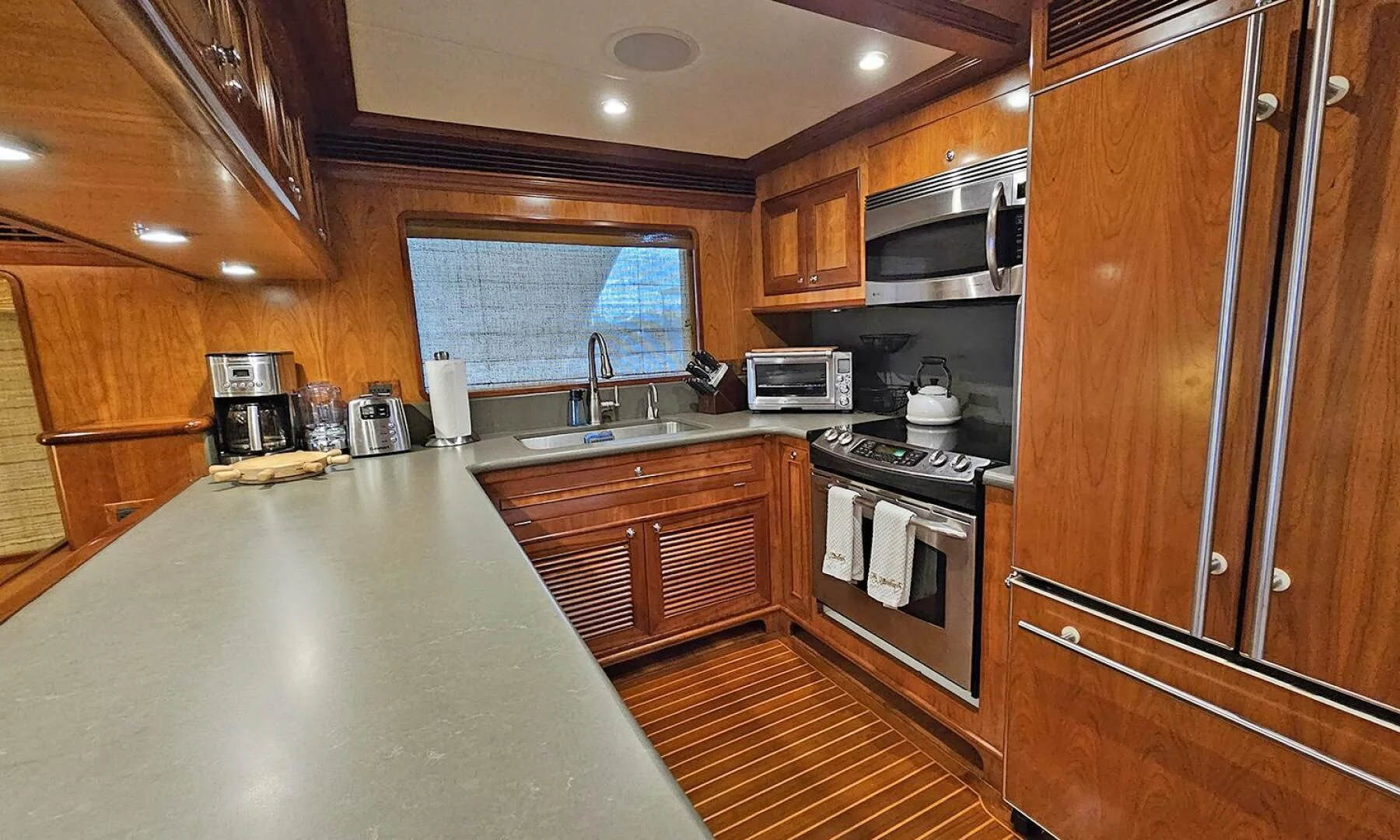 a kitchen with wooden cabinets aboard MY KIMBERLY Yacht for Sale