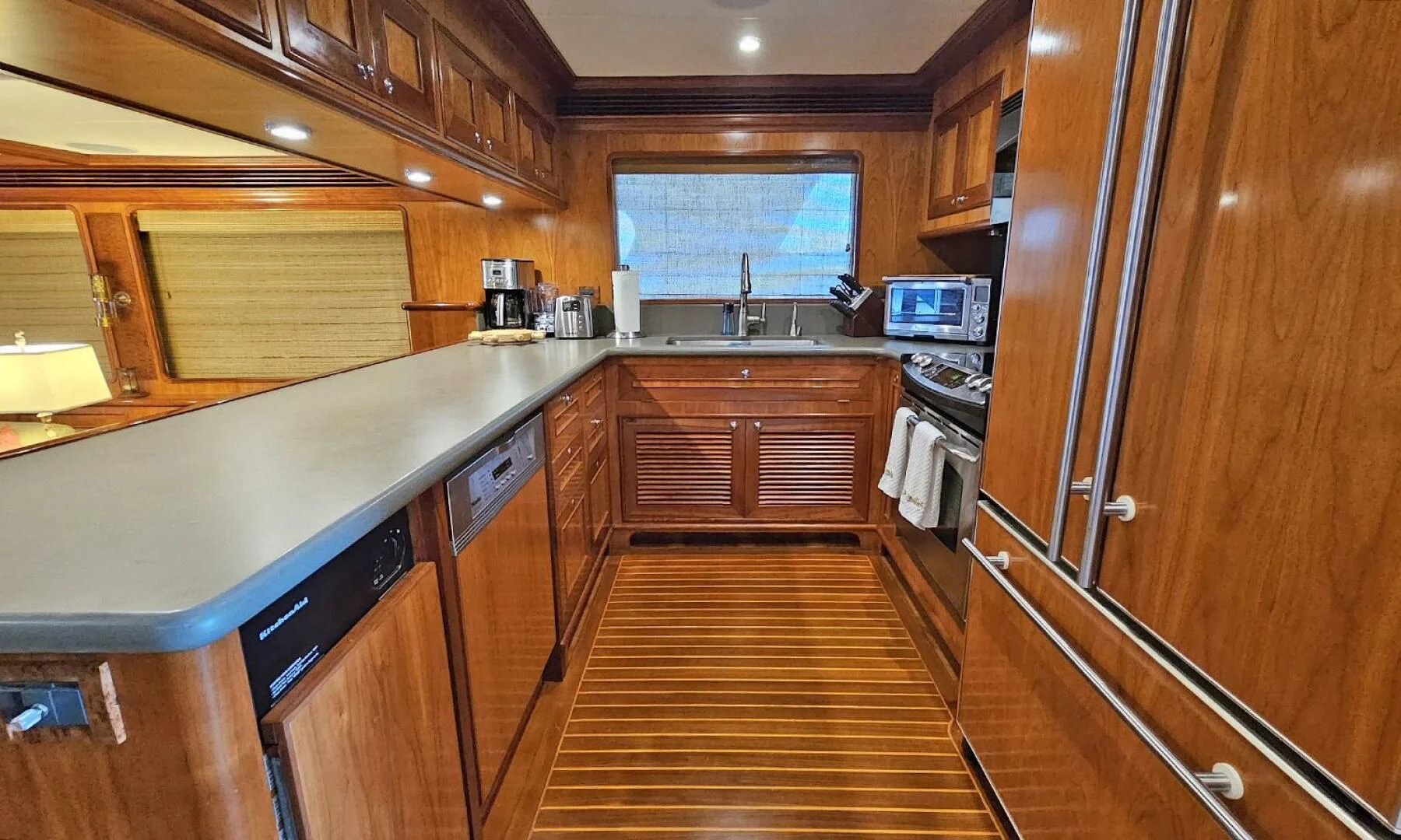 a kitchen with wooden cabinets aboard MY KIMBERLY Yacht for Sale
