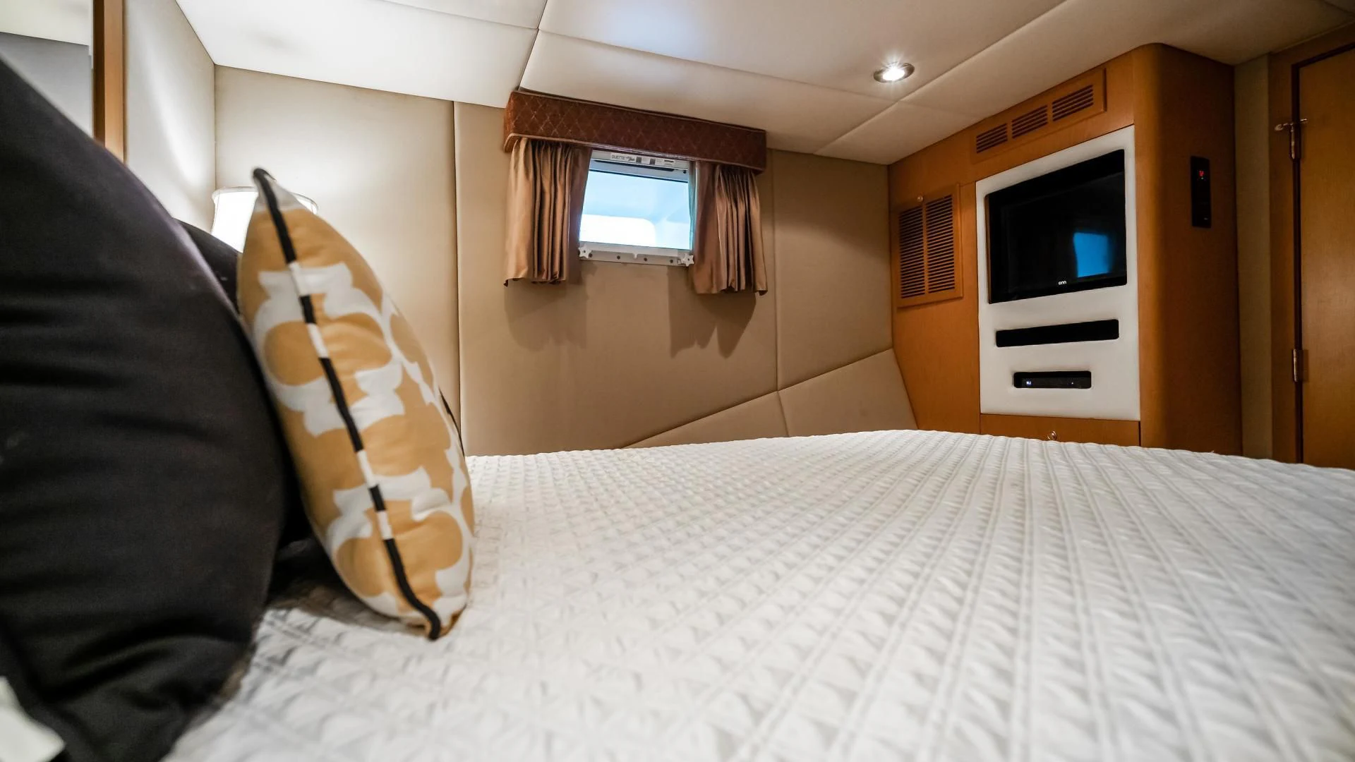 a bed with a white sheet and pillows aboard BUSINESS TRIP 2 Yacht for Sale