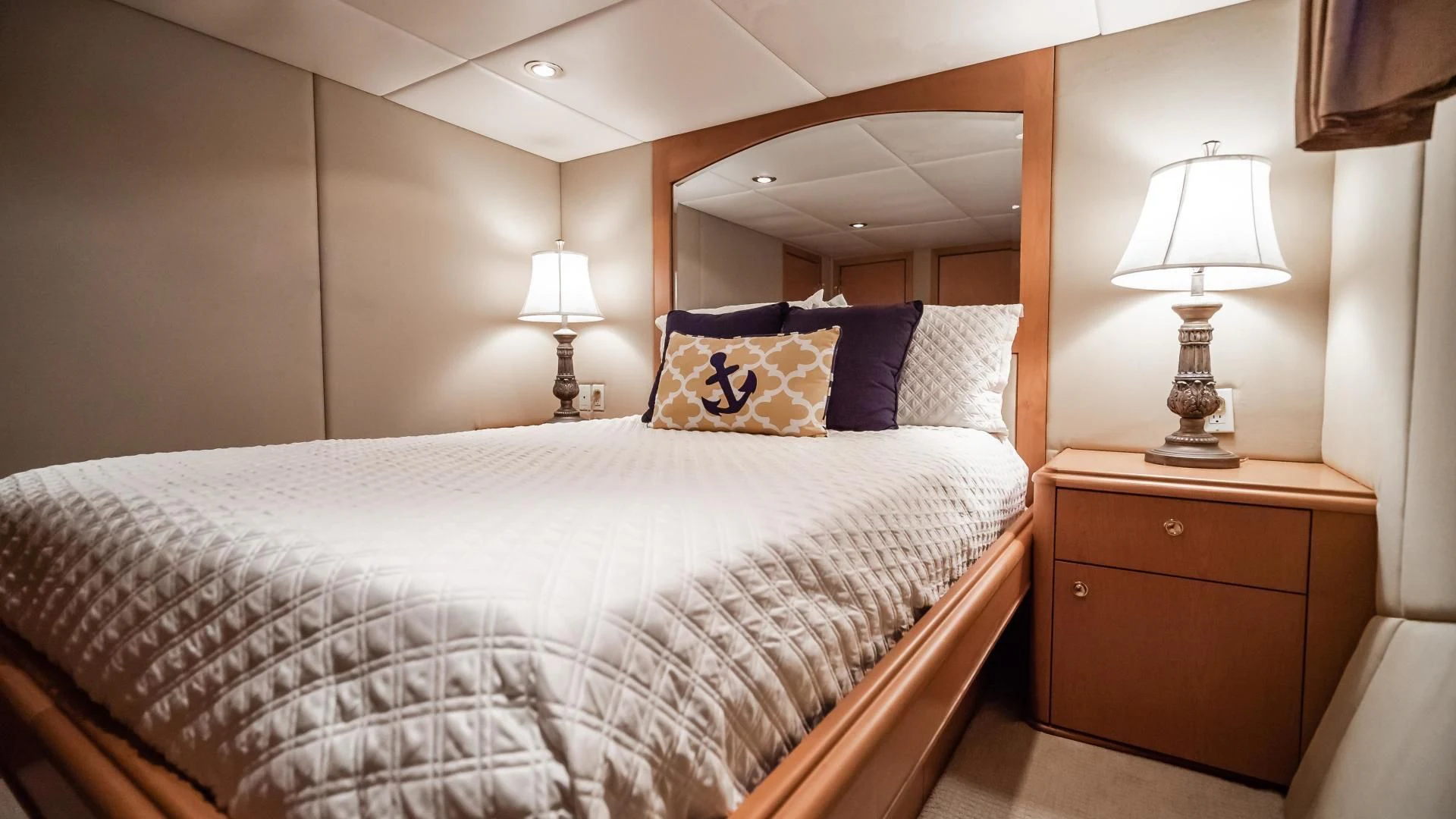 a bed with a white comforter and a blue and white pillow aboard BUSINESS TRIP 2 Yacht for Sale