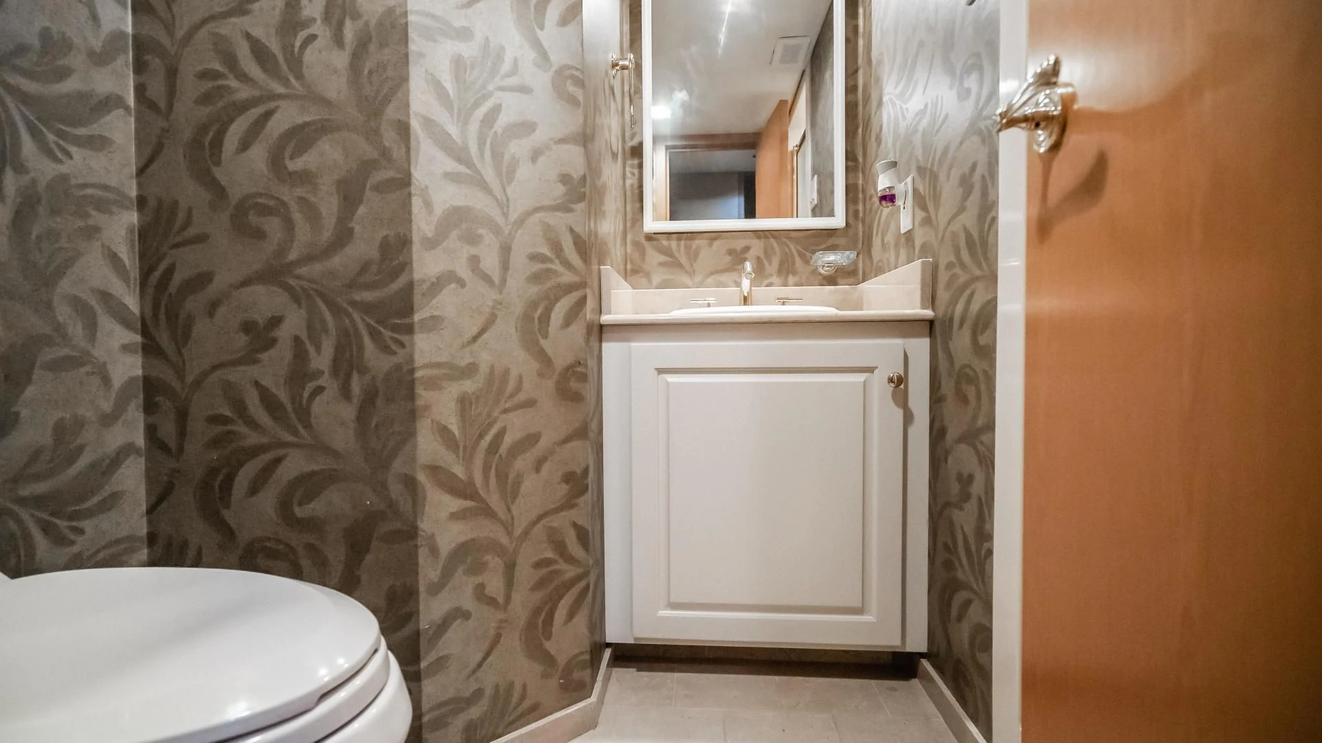 a bathroom with a toilet and sink aboard BUSINESS TRIP 2 Yacht for Sale
