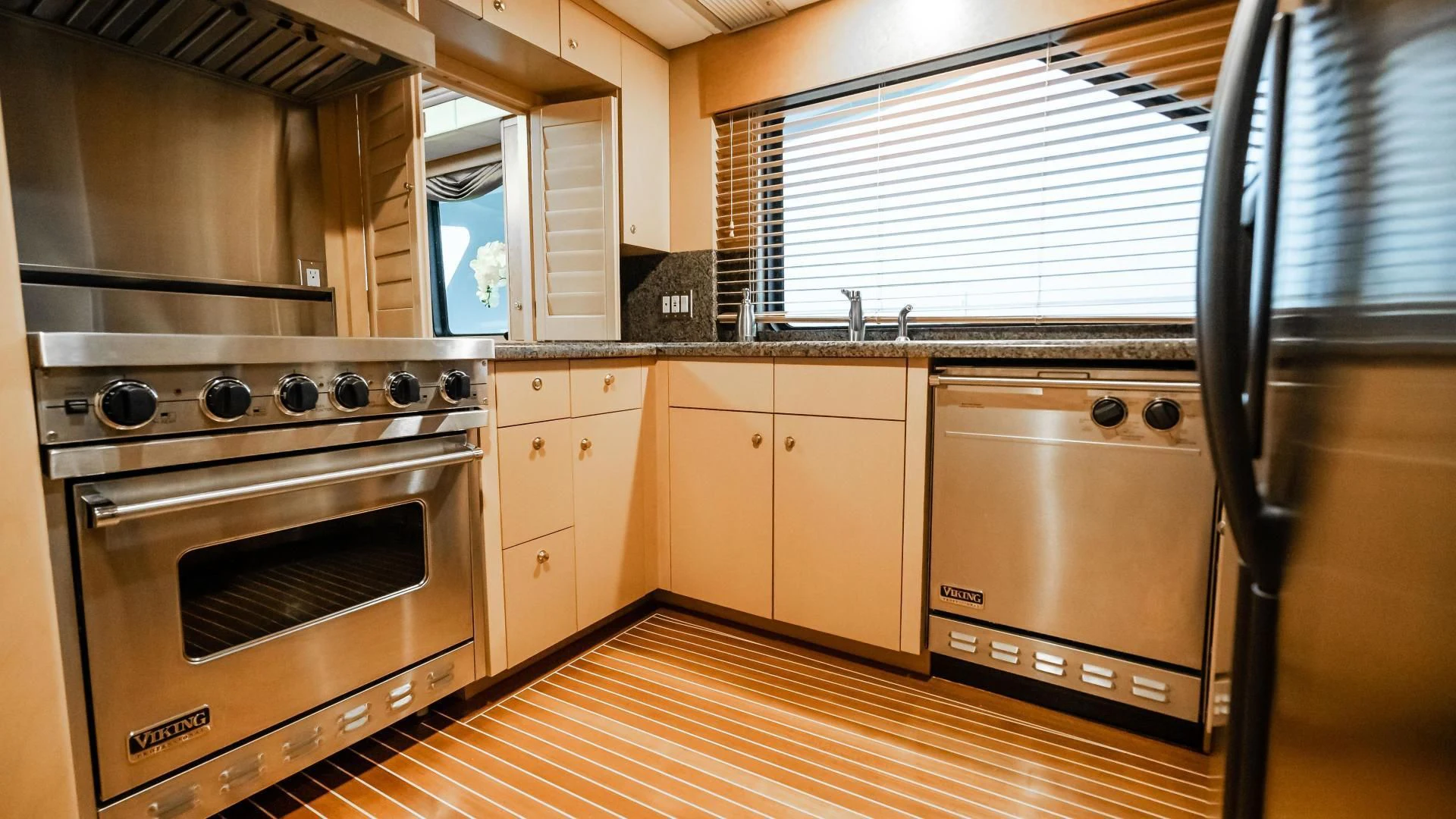 a kitchen with wooden cabinets aboard BUSINESS TRIP 2 Yacht for Sale