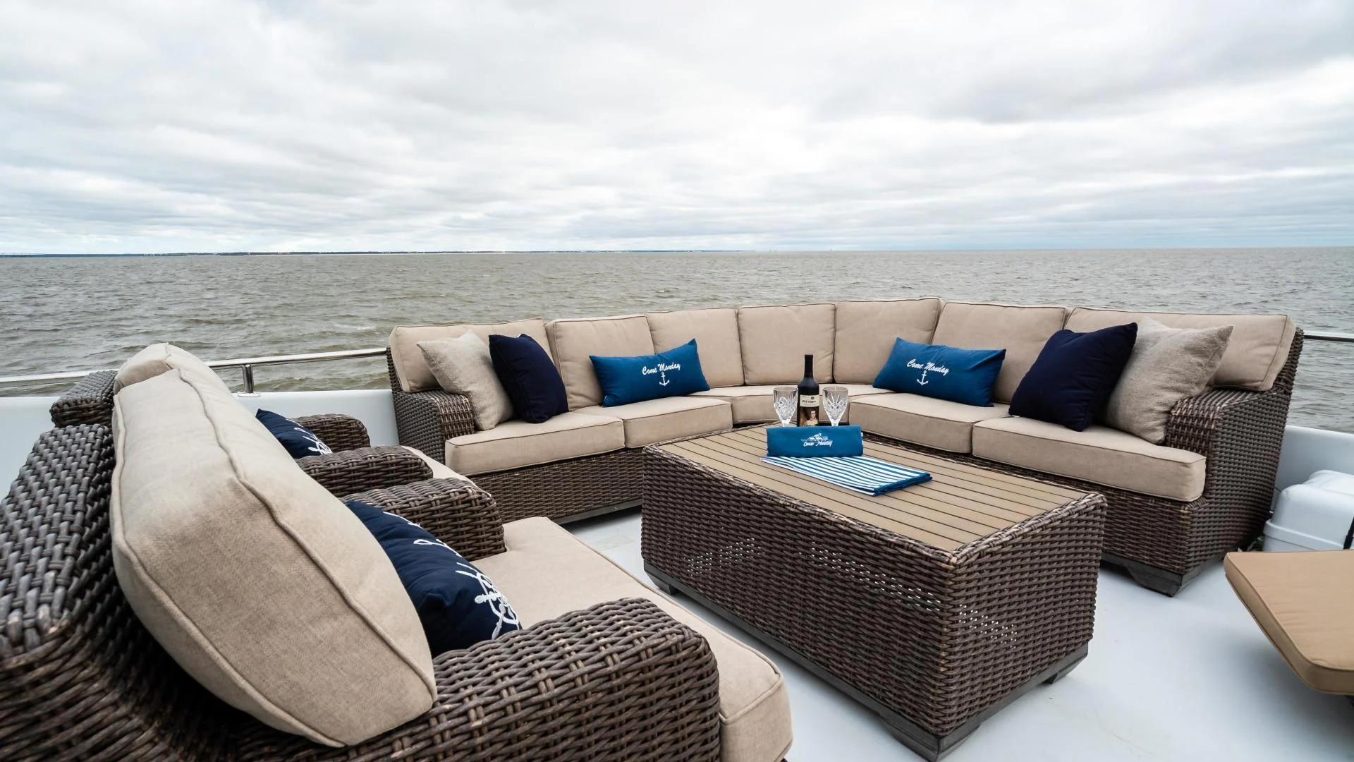 a couch and a table on a balcony overlooking a city aboard BUSINESS TRIP 2 Yacht for Sale
