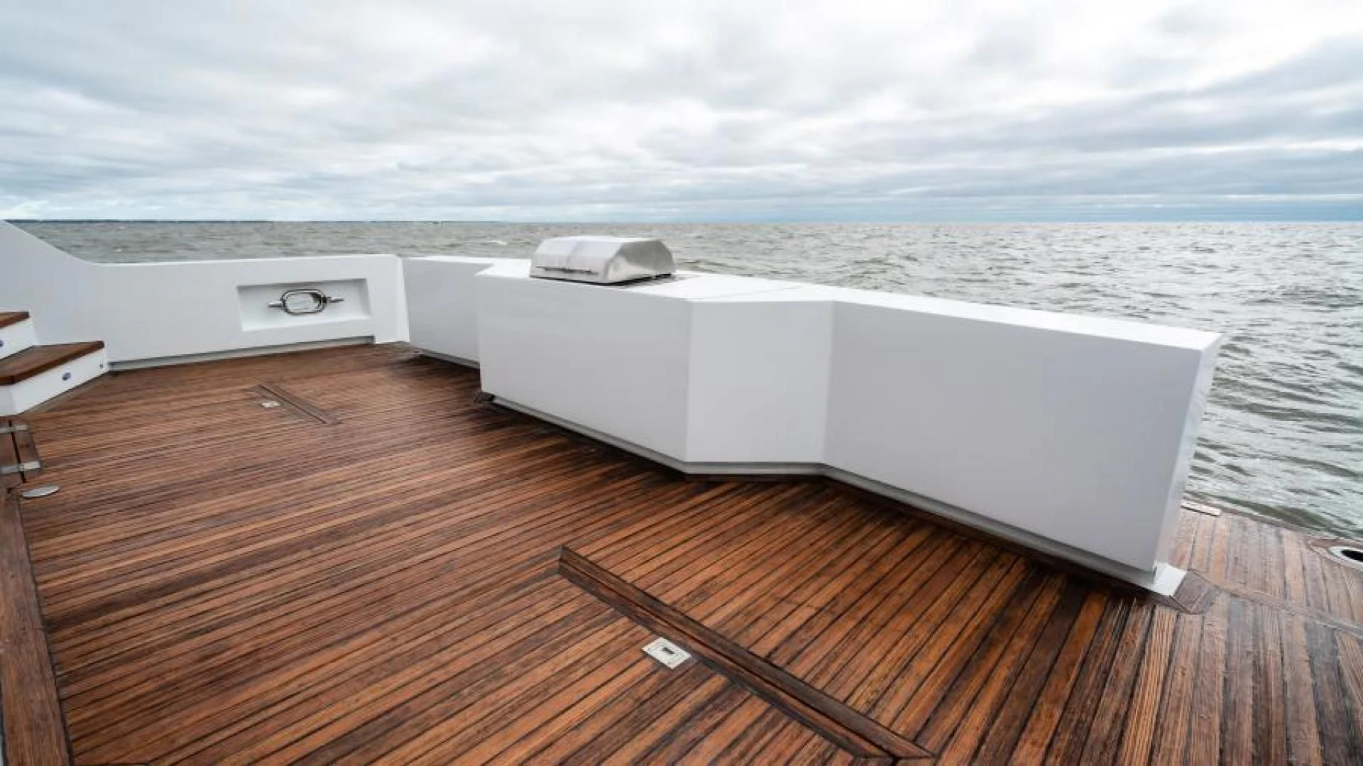 a white room with a large white bed and a wooden floor aboard BUSINESS TRIP 2 Yacht for Sale