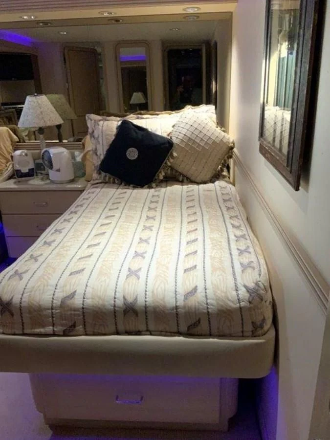 a bed with a white comforter aboard LADY GRACE Yacht for Sale