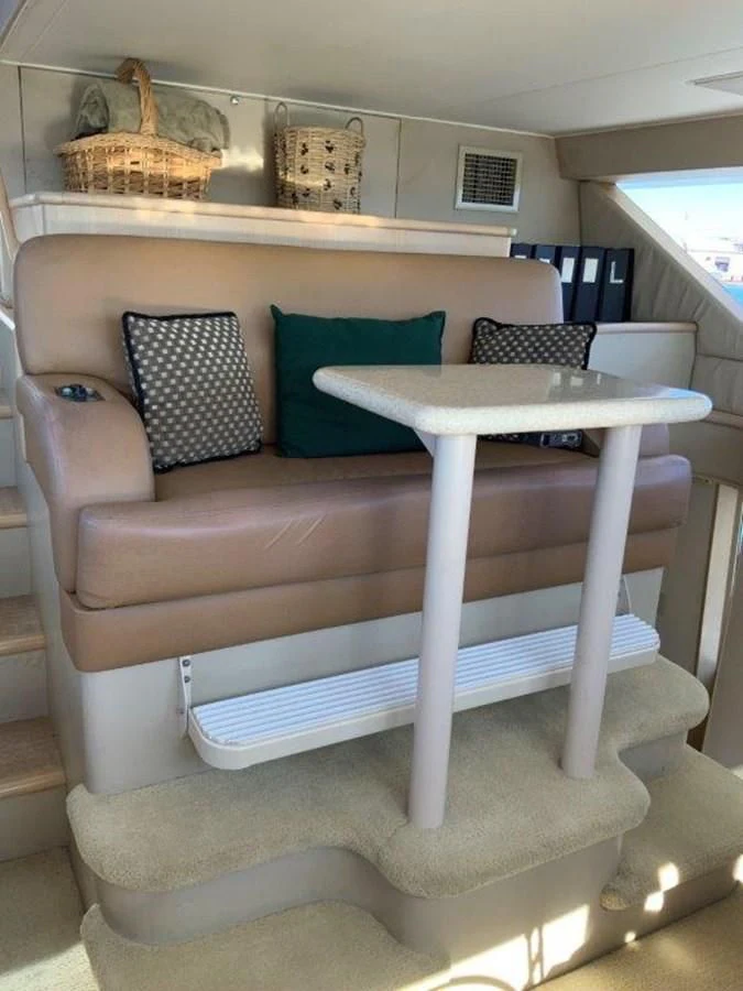 a couch with a table and a basket on top aboard LADY GRACE Yacht for Sale