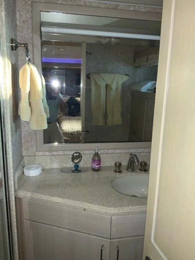 a bathroom with a sink and a mirror aboard LADY GRACE Yacht for Sale
