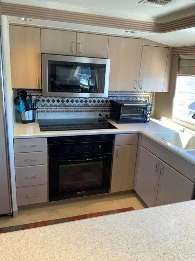 a kitchen with a microwave oven aboard LADY GRACE Yacht for Sale