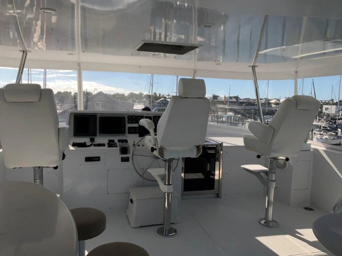 a room with several white chairs and a table with white chairs aboard LADY GRACE Yacht for Sale