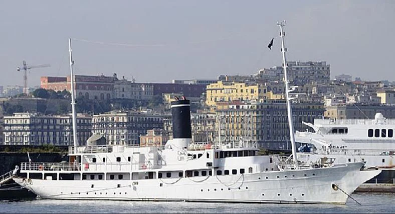 a large white boat in a harbor aboard ARGOSSY Yacht for Sale