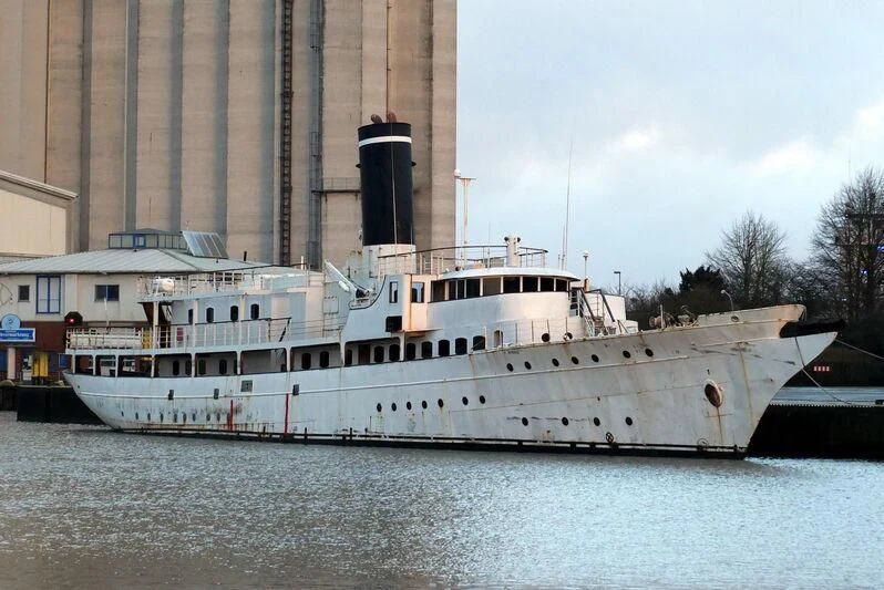 a large white boat in a harbor aboard ARGOSSY Yacht for Sale