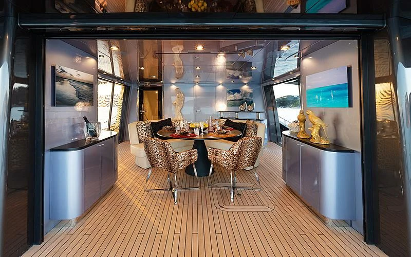 a room with a table chairs and a large mirror aboard FREEDOM Yacht for Sale