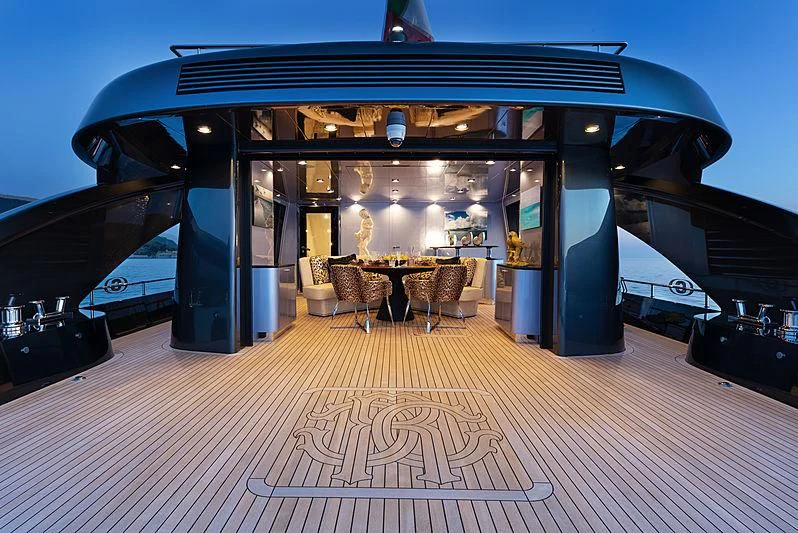 a large room with a table and chairs aboard FREEDOM Yacht for Sale