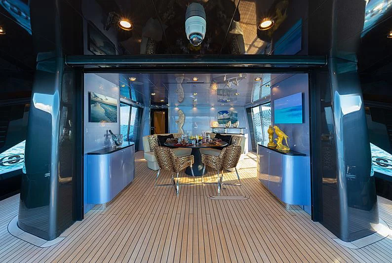 a room with tables and chairs aboard FREEDOM Yacht for Sale