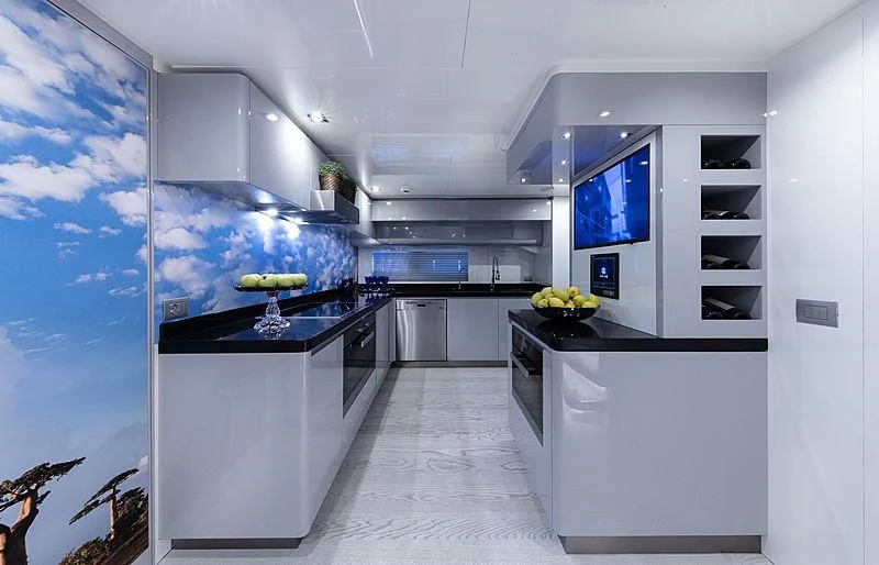 a kitchen with white cabinets aboard FREEDOM Yacht for Sale