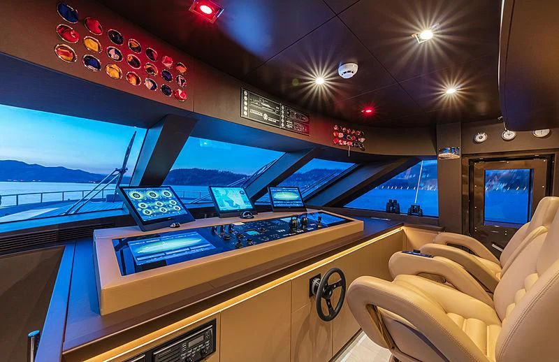 a room with a large display of screens and a game console aboard FREEDOM Yacht for Sale
