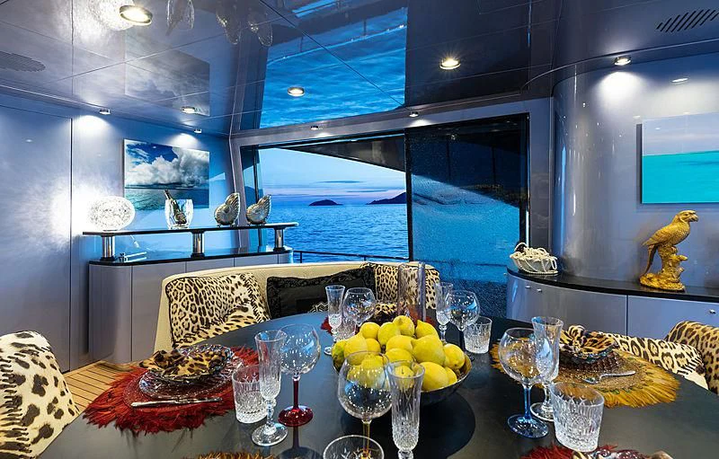 a table with wine glasses and food aboard FREEDOM Yacht for Sale